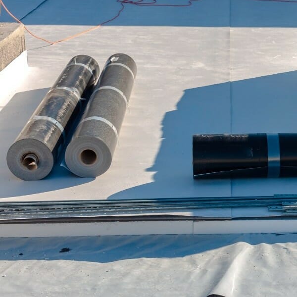 Flat top roofing materials set out on roof